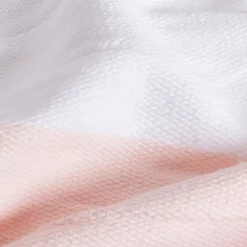 Couverture plaid 100% coton rose pâle avec pompons 130x170cm SLAVANN - SACASA