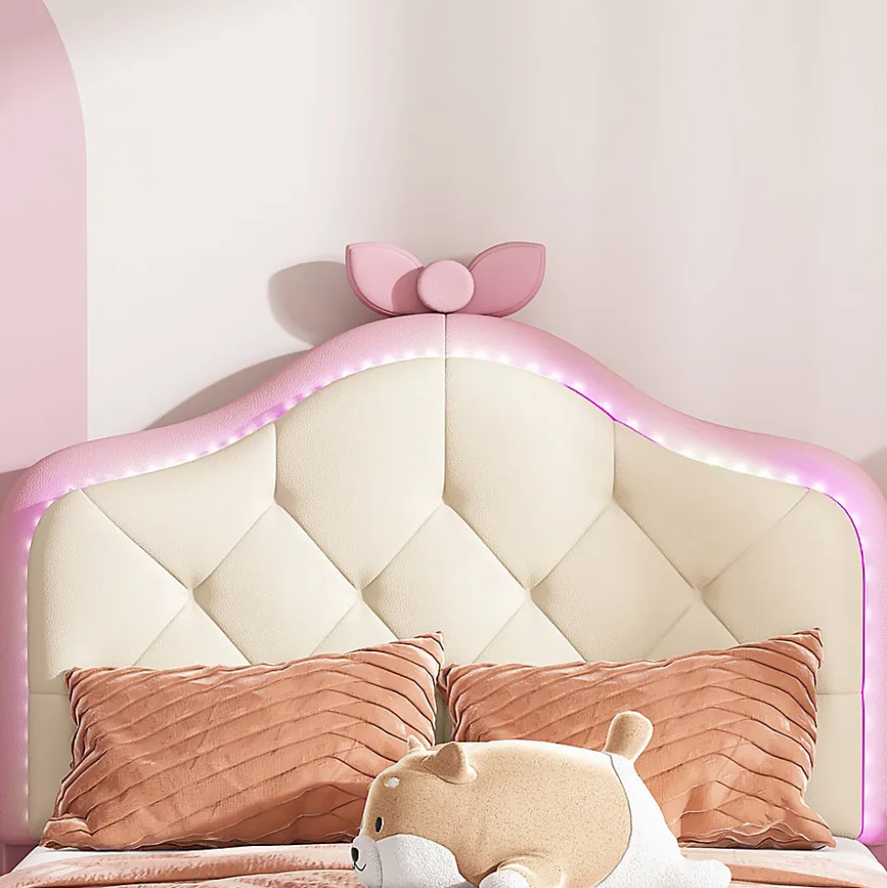 Lit enfant simple 90x200 cm rembourré avec bande LED colorée, tête ondulée et nœud décoratif, similicuir rose sans matelas